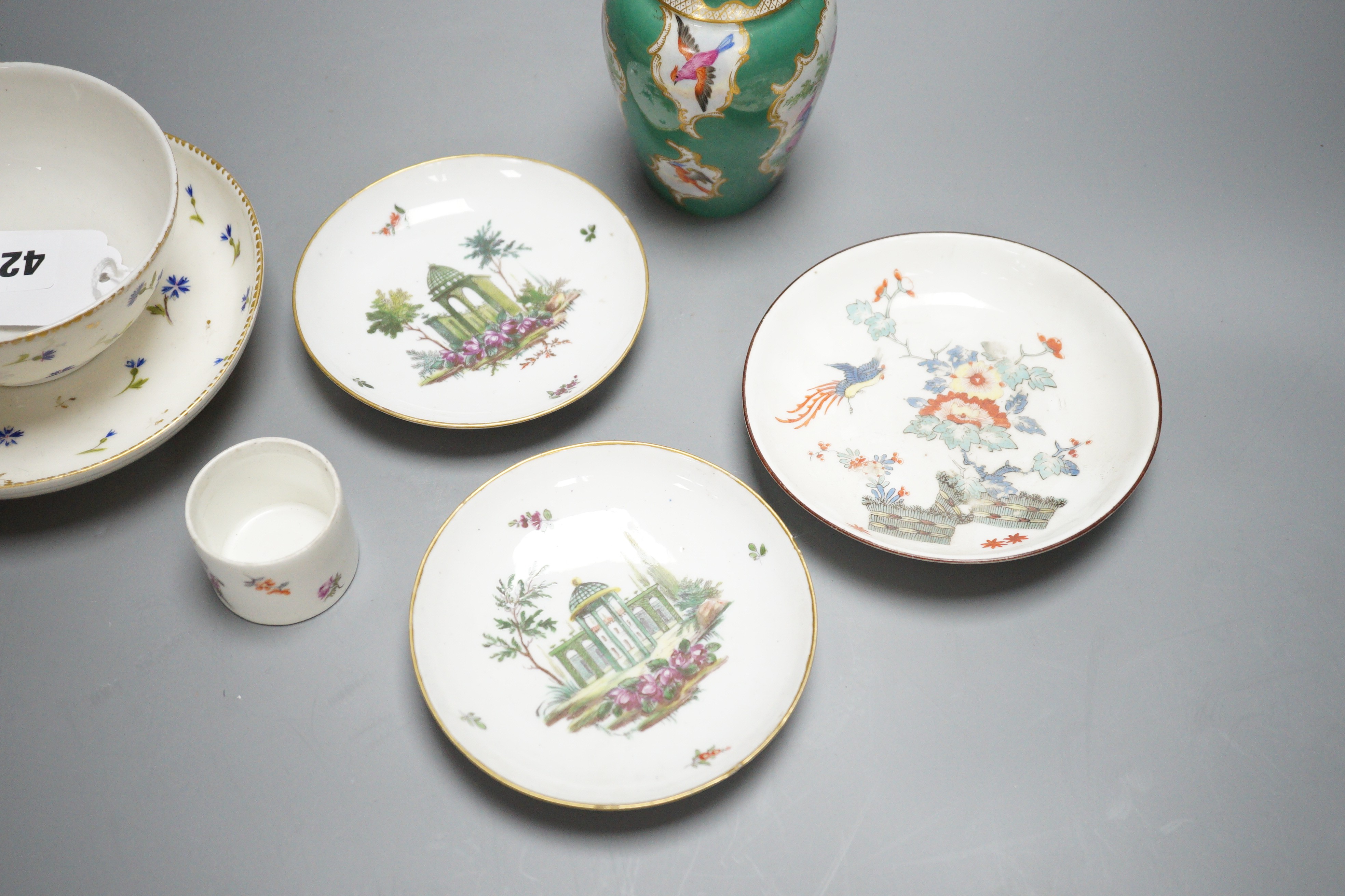 A rare Nyon porcelain slop bowl and saucer, a Meissen saucer and cylindrical pot and a pair of German saucers, red anchor marks
